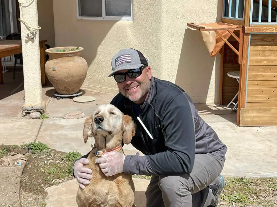 Cruces Scoopers owner greeting a customer dog