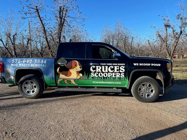 Cruces Scoopers dog waste removal truck displaying 575-642-3644 and We Scoop Poop branding